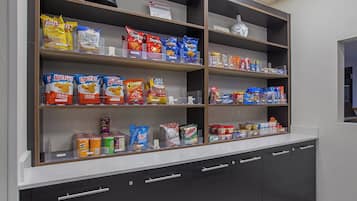 A snack display with various brands and prices.