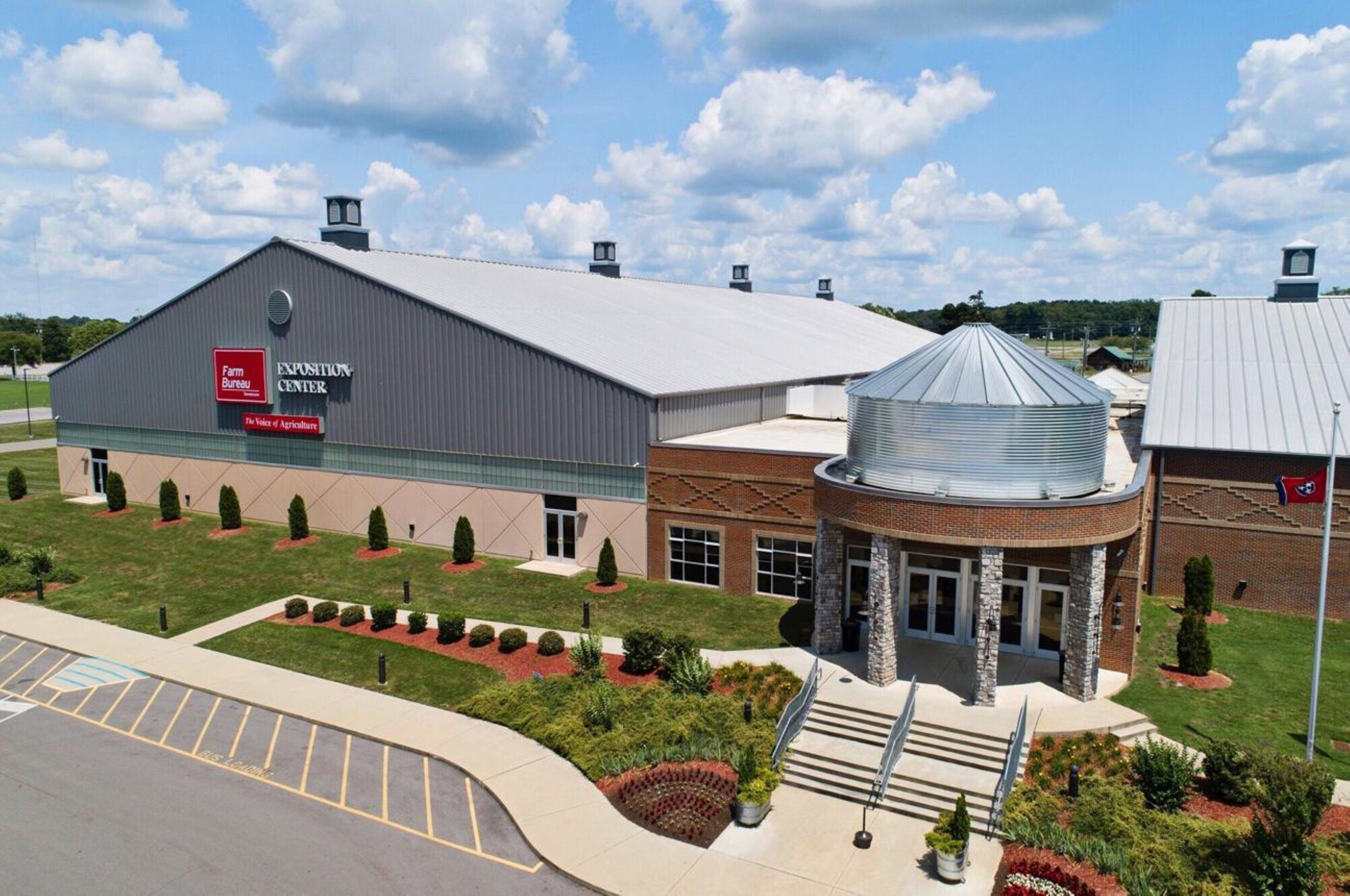 A large industrial building with a sign for the Farm Bureau Exposition Center.