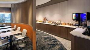 A modern hotel room with a dining area, a kitchen counter, and a refrigerator. - SpringHill Suites by Marriott Albany-Colonie (Albany)