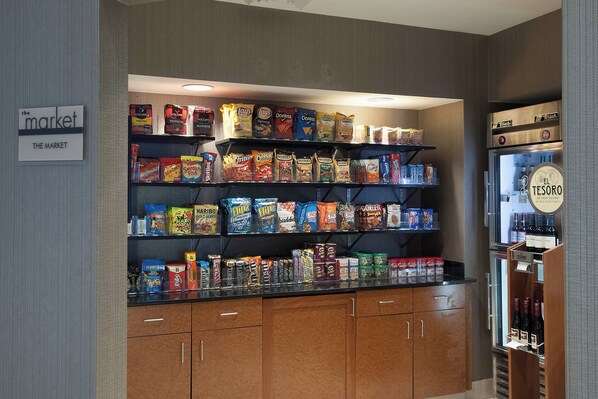A snack and beverage display in a store with a refrigerated section on the right.