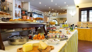 Een buffet met diverse etenswaren, zoals kaas, fruit en drankjes.