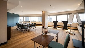 A modern conference room with a long table, chairs, and a projector screen. - Metropolitan Hotel Sofia, a member of Radisson Individuals (Sofia)