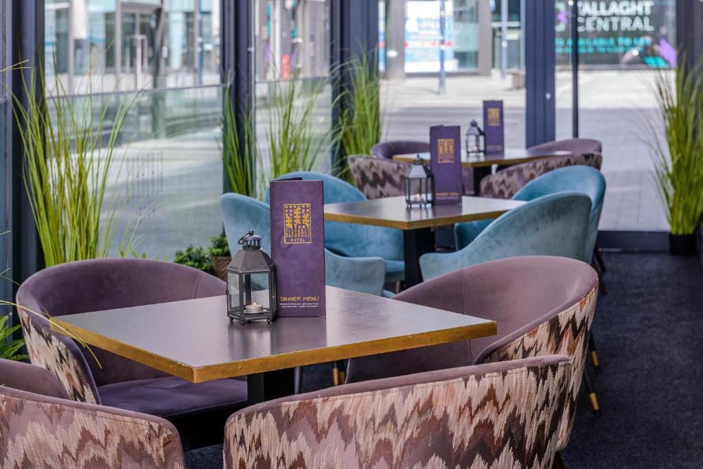 A restaurant interior with seating arrangements, tables, and a menu stand.
