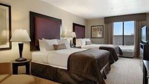 A hotel room with two beds, a desk, a chair, and a large window. - Wingate by Wyndham Yuma (Yuma)