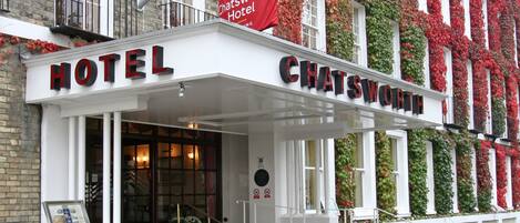 A hotel entrance with a sign reading "CHATSWORTH HOTEL".