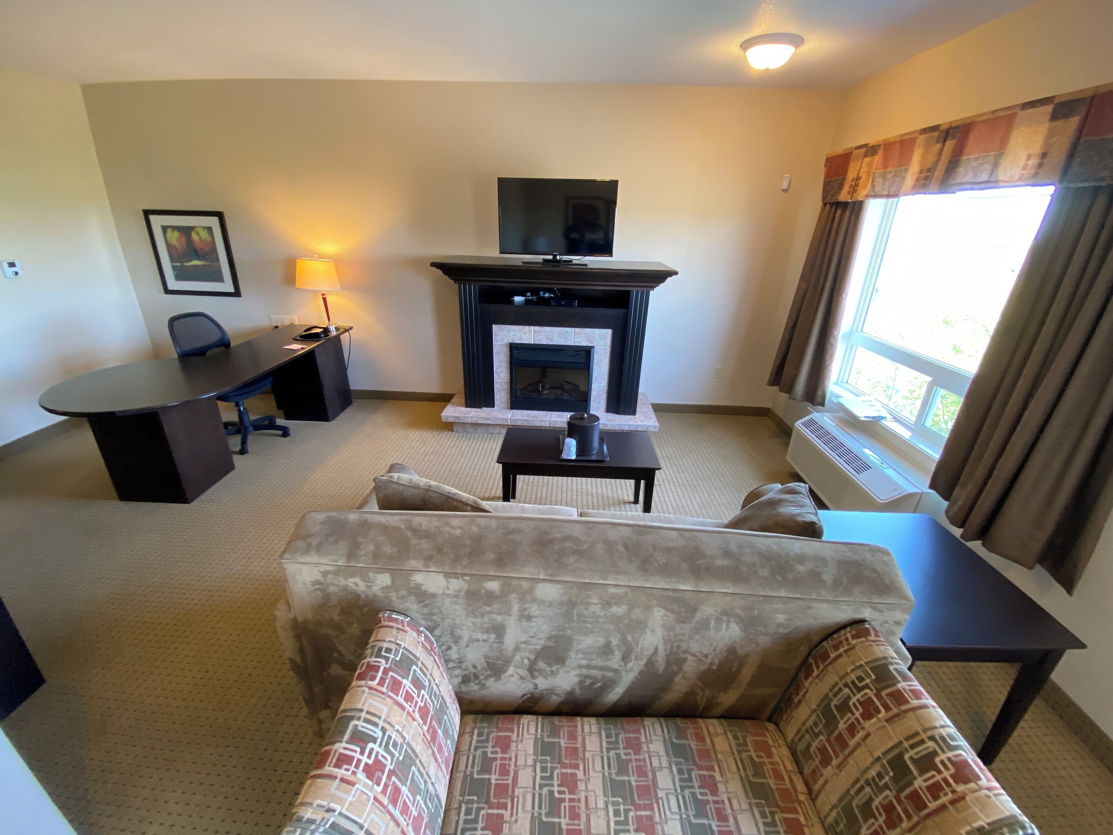 suite, 1 queen bed with sofa bed, non smoking, fireplace | living area | flat-screen tv, pay films