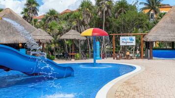 A water park area with a blue slide, a water fountain, and a sign for Jelly's Playhouse.