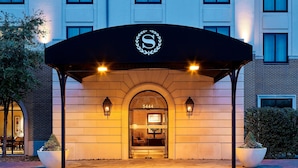 A hotel entrance with a black awning, a large arched doorway, and the number 5444 above it. - Sheraton Stonebriar Hotel (Frisco)