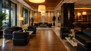 A modern lobby with leather sofas, a marble coffee table, and large pendant lights. - ADM Grand Hotel (Istanbul)