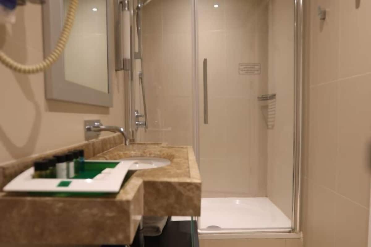 Bathroom | Deep soaking tub, rainfall showerhead, designer toiletries, hair dryer