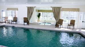 An indoor swimming pool with four chairs and a hot tub. - Pointe at Castle Hill Resort (Cavendish)