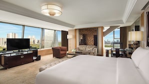 A hotel room with a large bed, a television, a desk, and a view of the cityscape. - InterContinental Chengdu Century City by IHG (Chengdu)