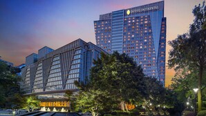 A modern hotel with a prominent InterContinental sign, featuring a sleek, multi-story structure with a mix of glass and metal facades. - InterContinental Chengdu Century City by IHG (Chengdu)
