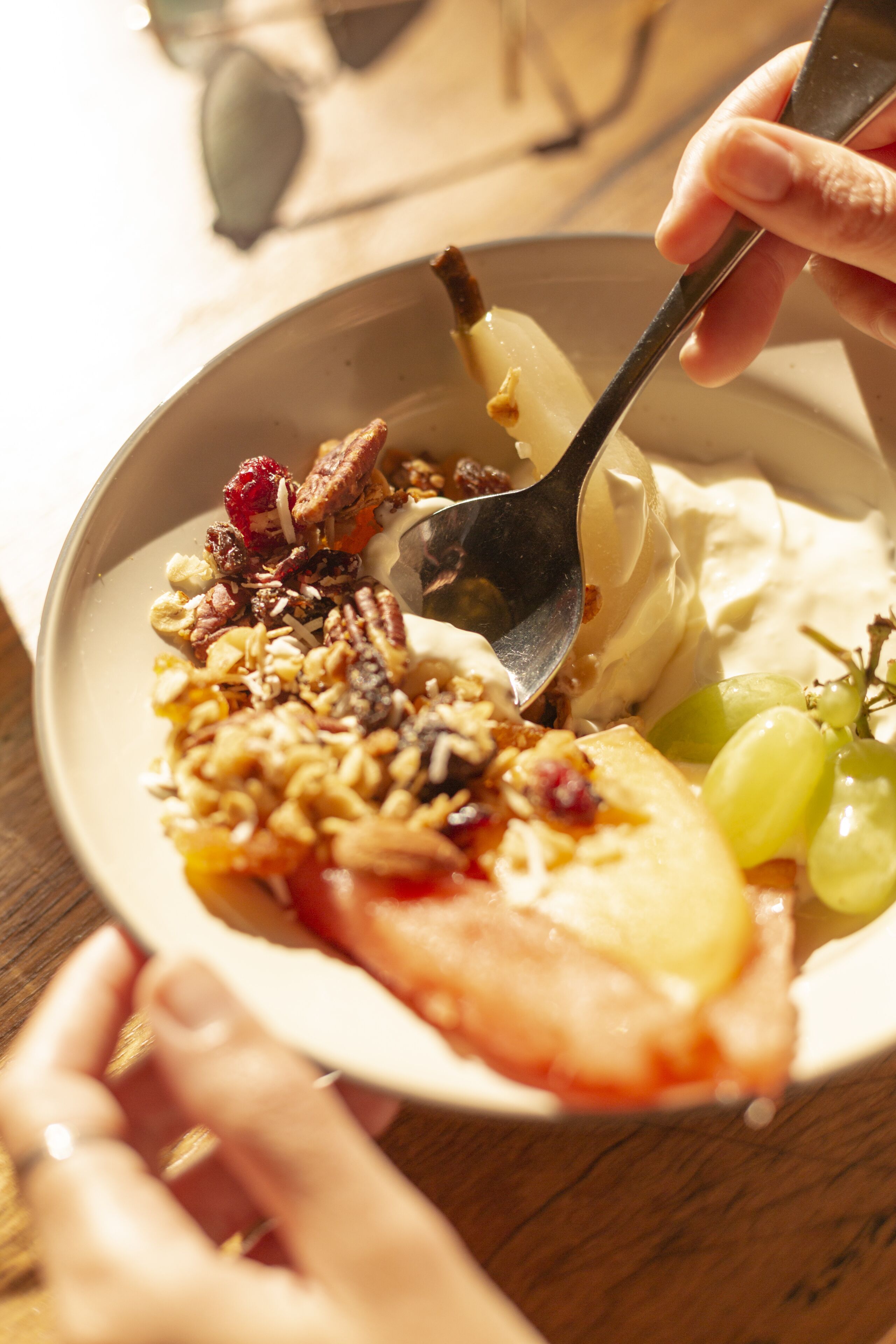 A bowl of yogurt with fruits and granola.