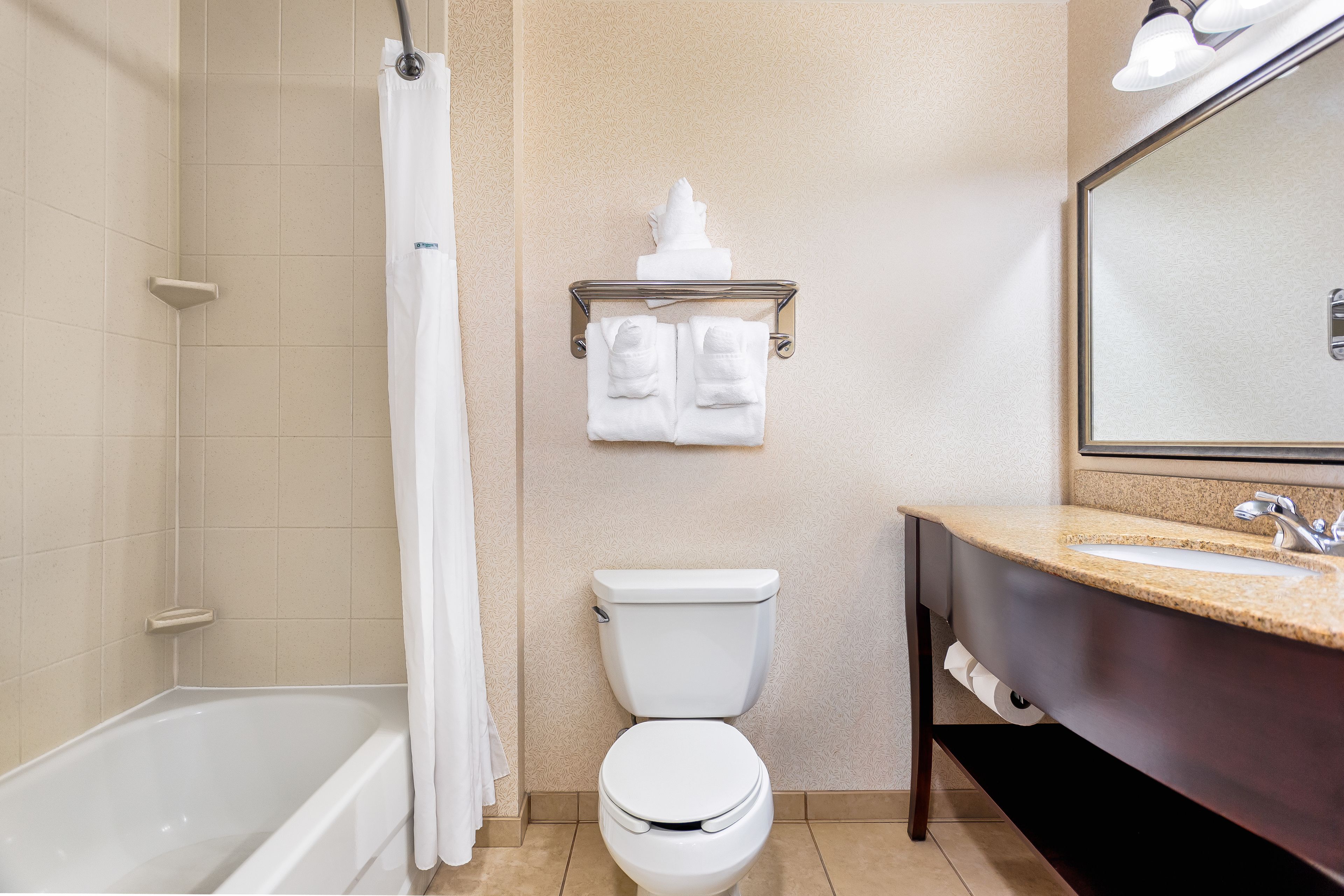 combined shower/bathtub, designer toiletries, hair dryer, towels