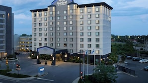 A multi-story hotel with a prominent sign at the top. - Fairfield Inn & Suites by Marriott Montreal Airport (Dorval)