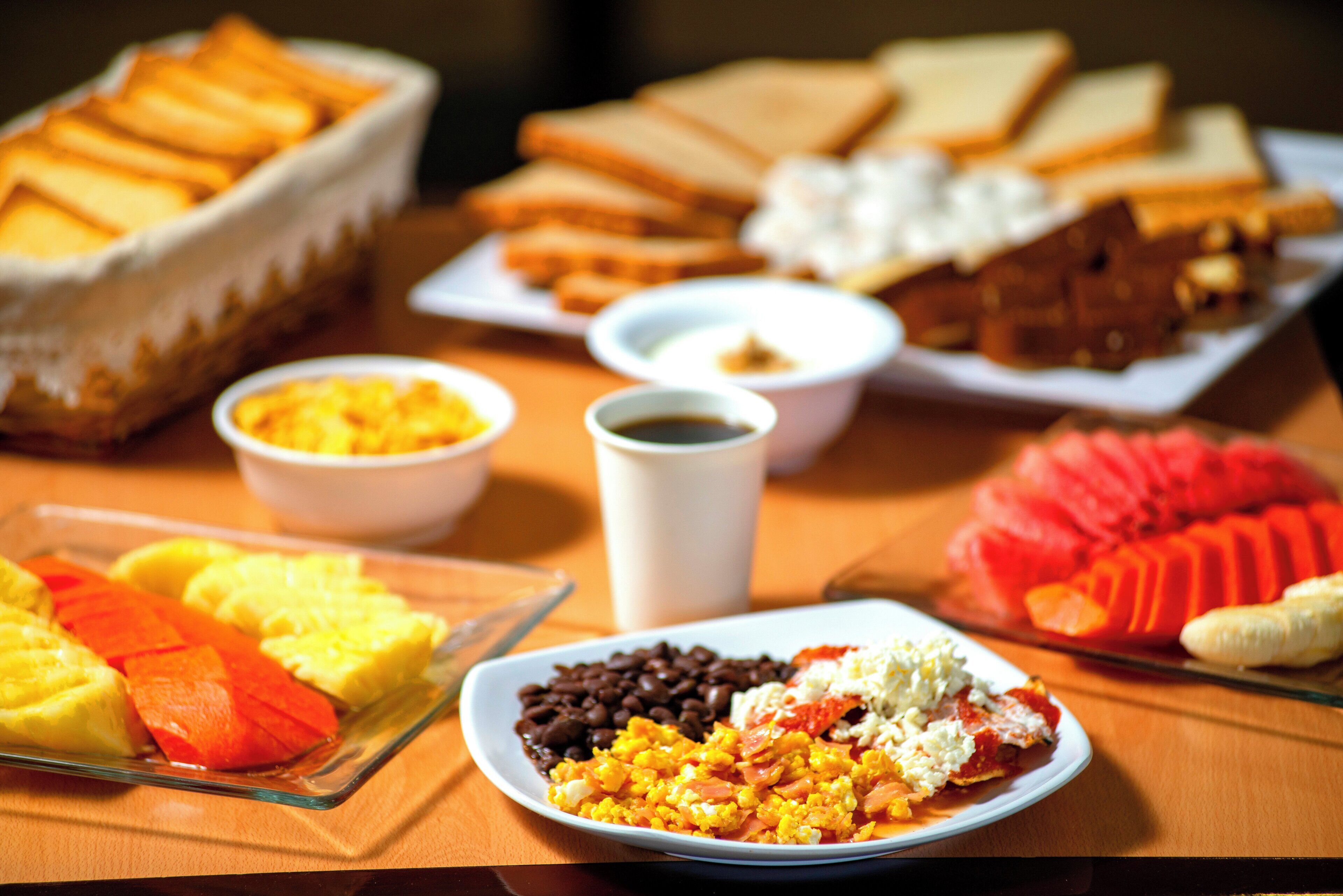 A breakfast buffet with various food items and beverages.