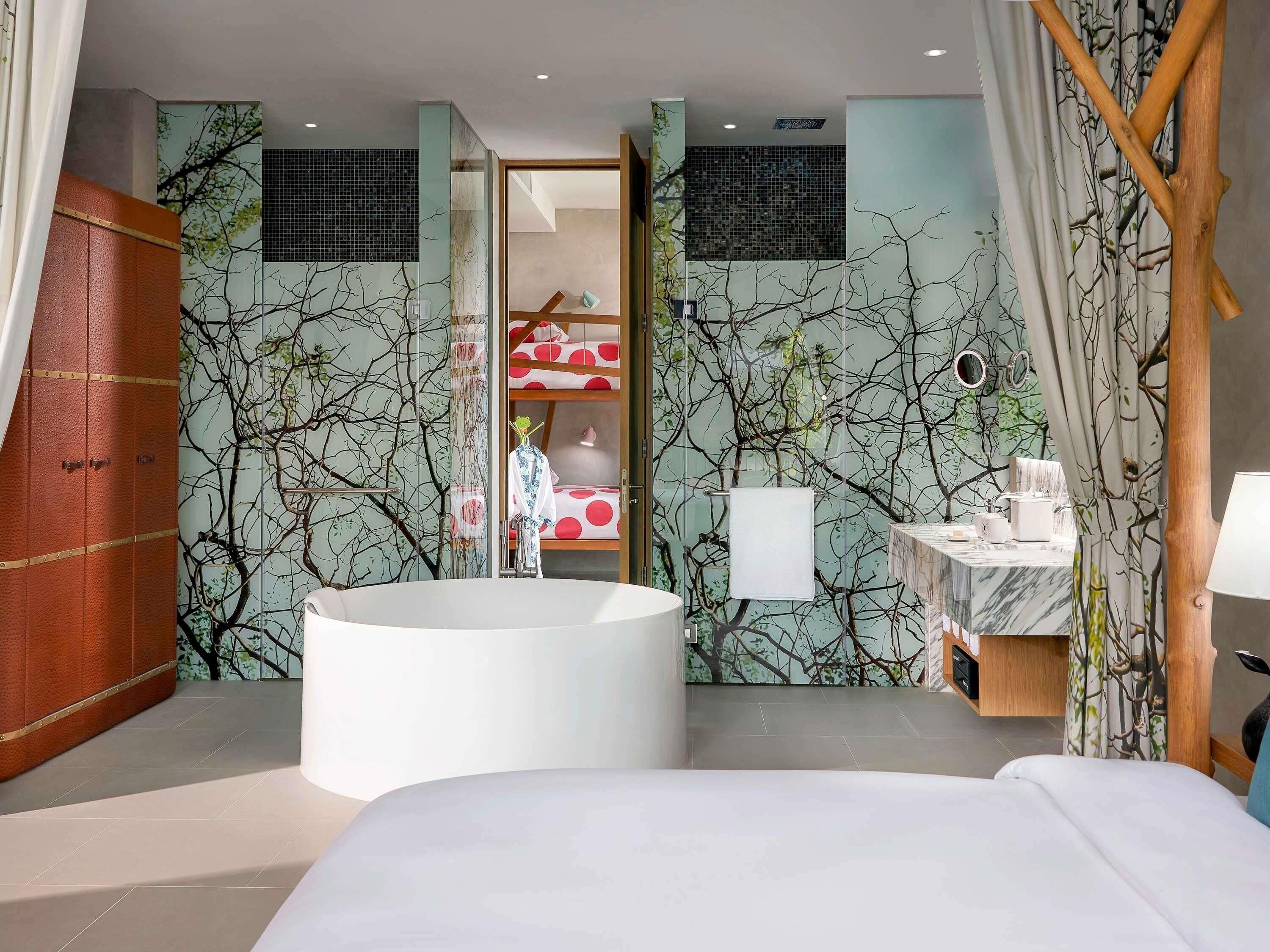 A modern bathroom with a freestanding bathtub, a vanity with a mirror, and a shower area.