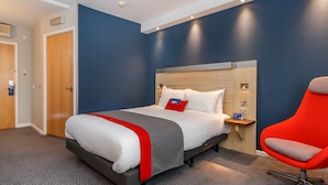 A hotel room with a bed, a nightstand, a red chair, and a wooden headboard. - Holiday Inn Express Walsall M6J10 by IHG (Walsall)