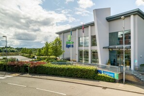 Welcome to the Holiday Inn Express, featuring a modern entrance with glass doors and windows.