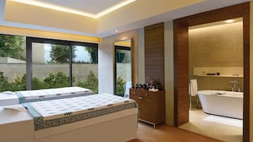 Relax in a spacious room with a large bed, dresser, and bathtub, offering a view of the outdoors.