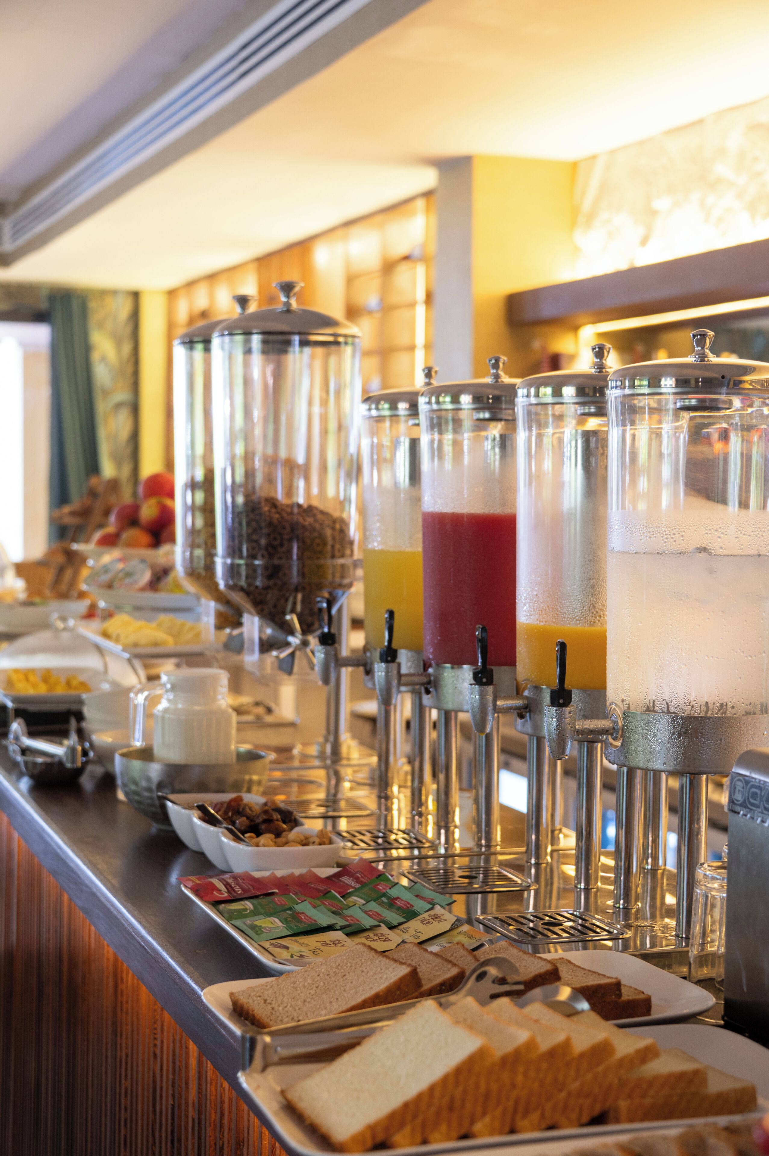 A buffet setup with various food items and beverages.