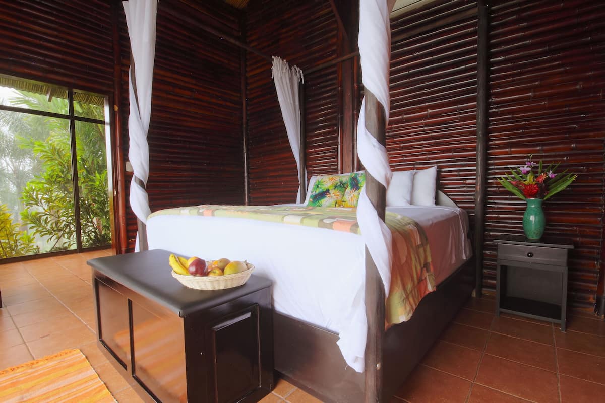 A bedroom with a bed, bedside table, and a nightstand.