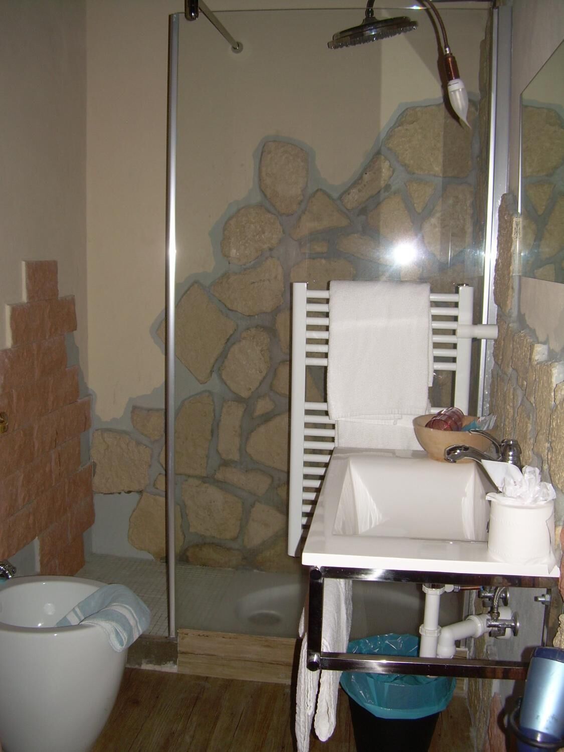 A bathroom with a shower, toilet, and sink.