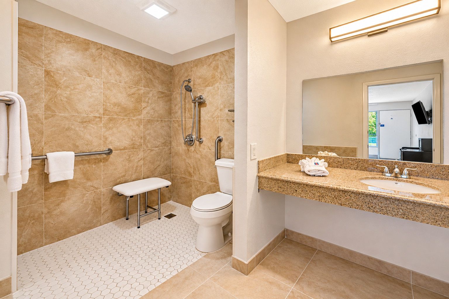 A modern bathroom with a shower, toilet, and vanity.