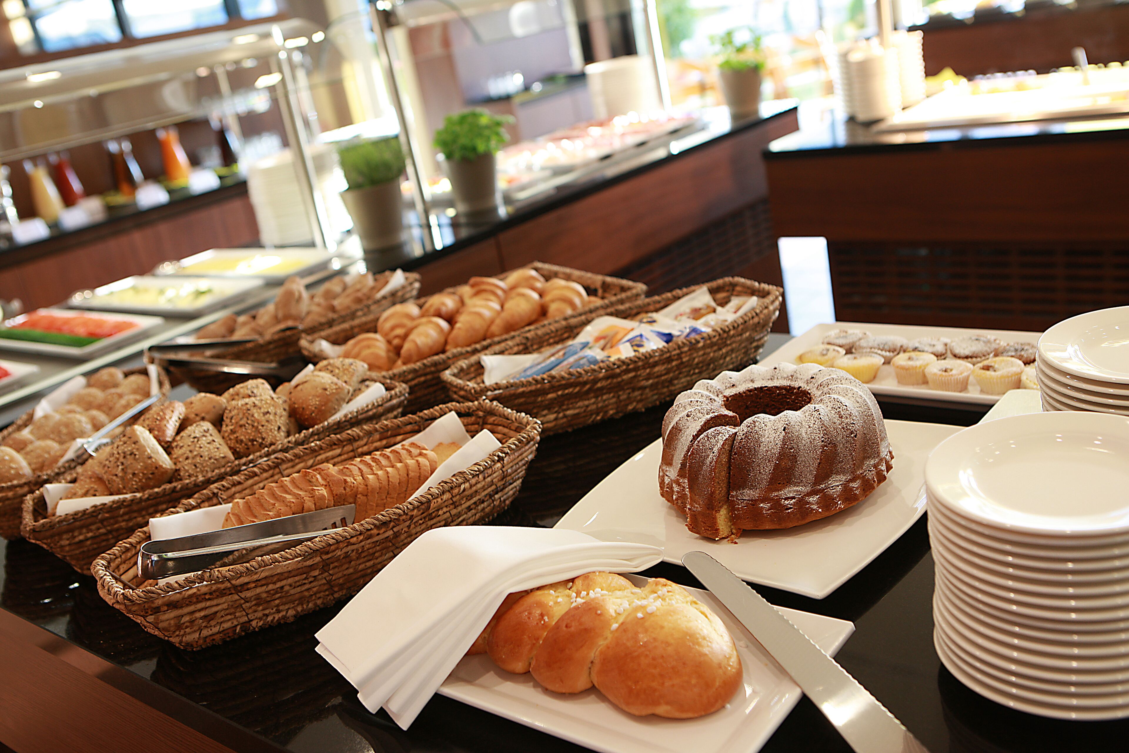 A buffet with various baked goods and pastries.
