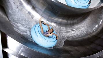 A person in a blue water slide tube.