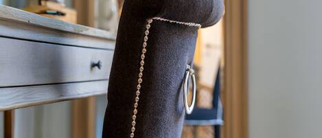 A chair with a beaded chain detail.