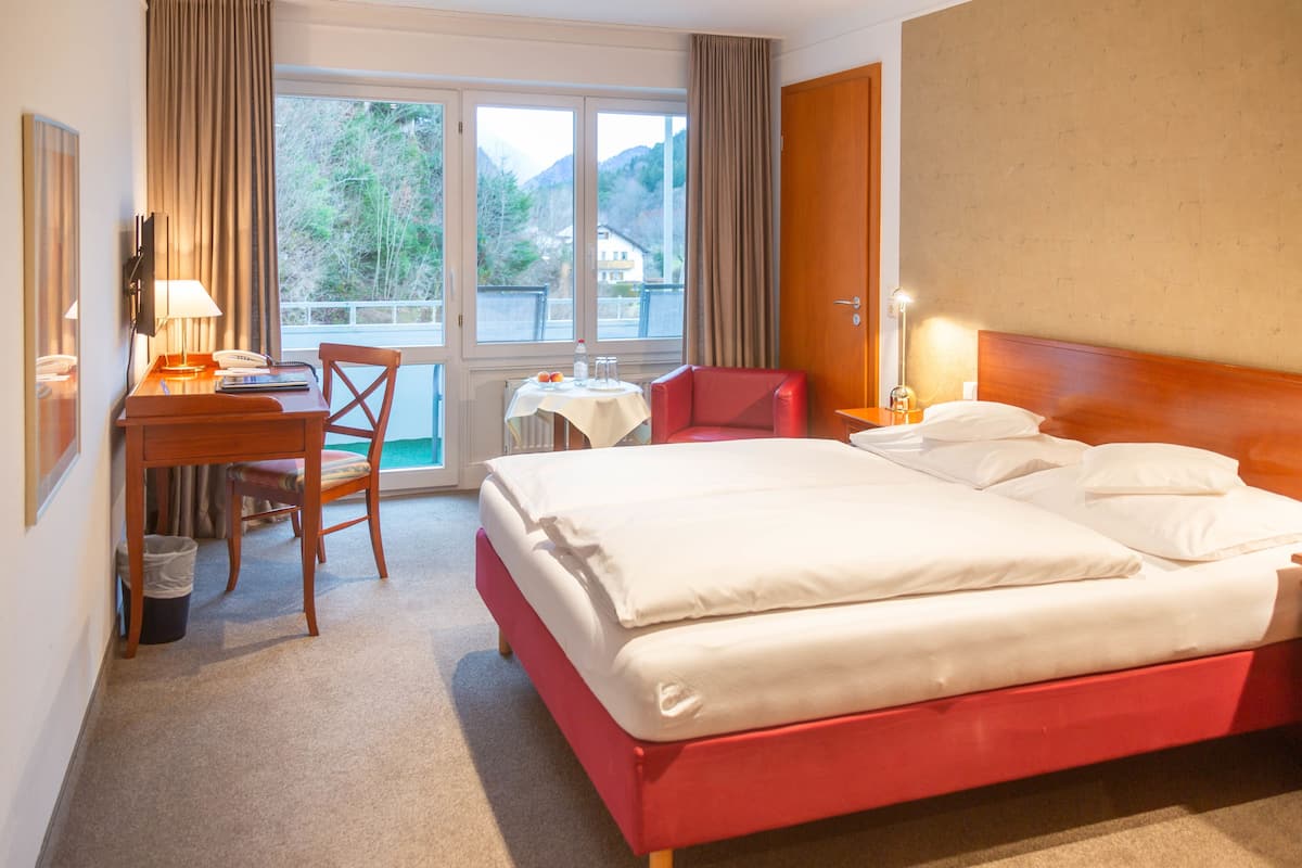 hypo-allergenic bedding, desk, laptop workspace, blackout curtains