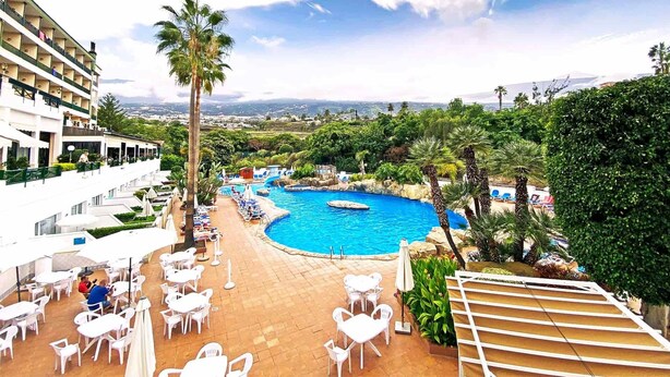 A resort with a swimming pool, outdoor seating, and a view of the landscape. - BLUESEA Costa Jardín Spa (Puerto de la Cruz)