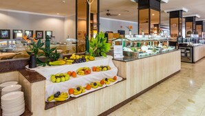 A buffet area with a variety of fruits and vegetables displayed on a counter, surrounded by a clean and modern interior. - BLUESEA Costa Jardín Spa (Puerto de la Cruz)