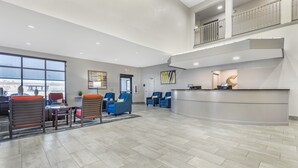 A spacious lobby with a reception desk, seating area, and a view of the outside. - Comfort Suites Nacogdoches (Nacogdoches)