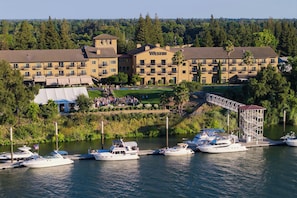 A waterfront hotel with multiple buildings, a dock with boats, and a bridge. - The Westin Sacramento Hotel & Marina (Sacramento)