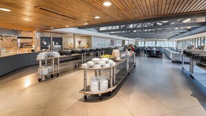 A spacious cafeteria with high ceilings, modern lighting, and a clean, organized layout. - Crowne Plaza Atlanta SW - Peachtree City by IHG (Peachtree City)