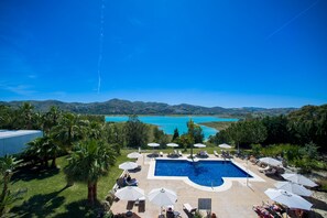 Outdoor pool, open 9:00 AM to 9:00 PM, pool umbrellas, pool loungers