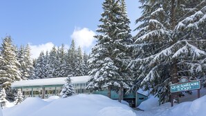 A snow-covered lodge with a sign reading "Quicksilver Lodge." - Crystal Mountain Hotels (Enumclaw)