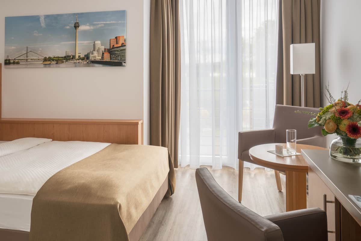 Hypo-allergenic bedding, desk, laptop workspace, blackout curtains