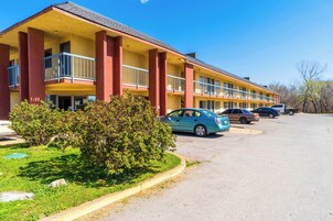 A motel with multiple balconies and a parking lot.