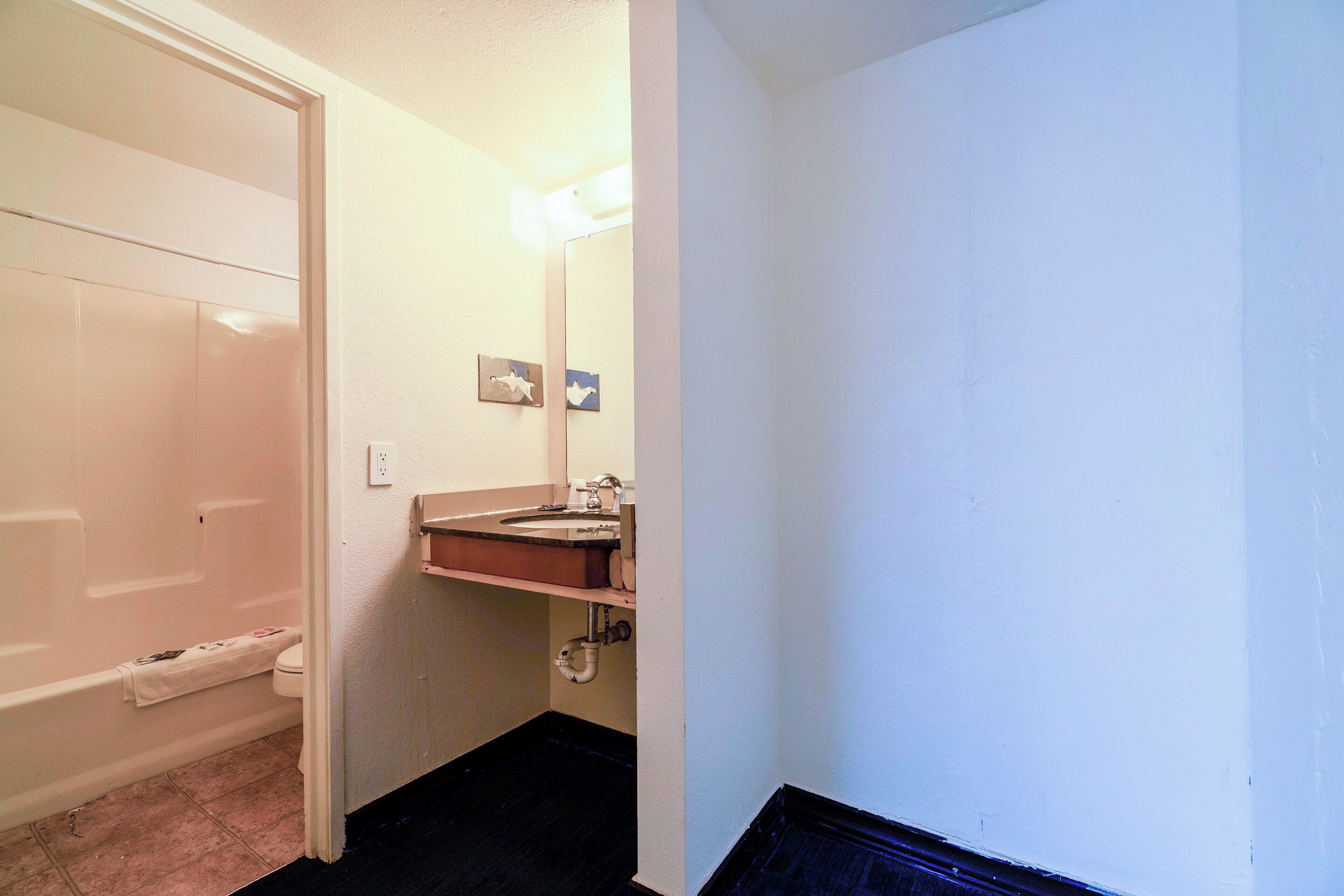 A bathroom with a bathtub, toilet, and sink.