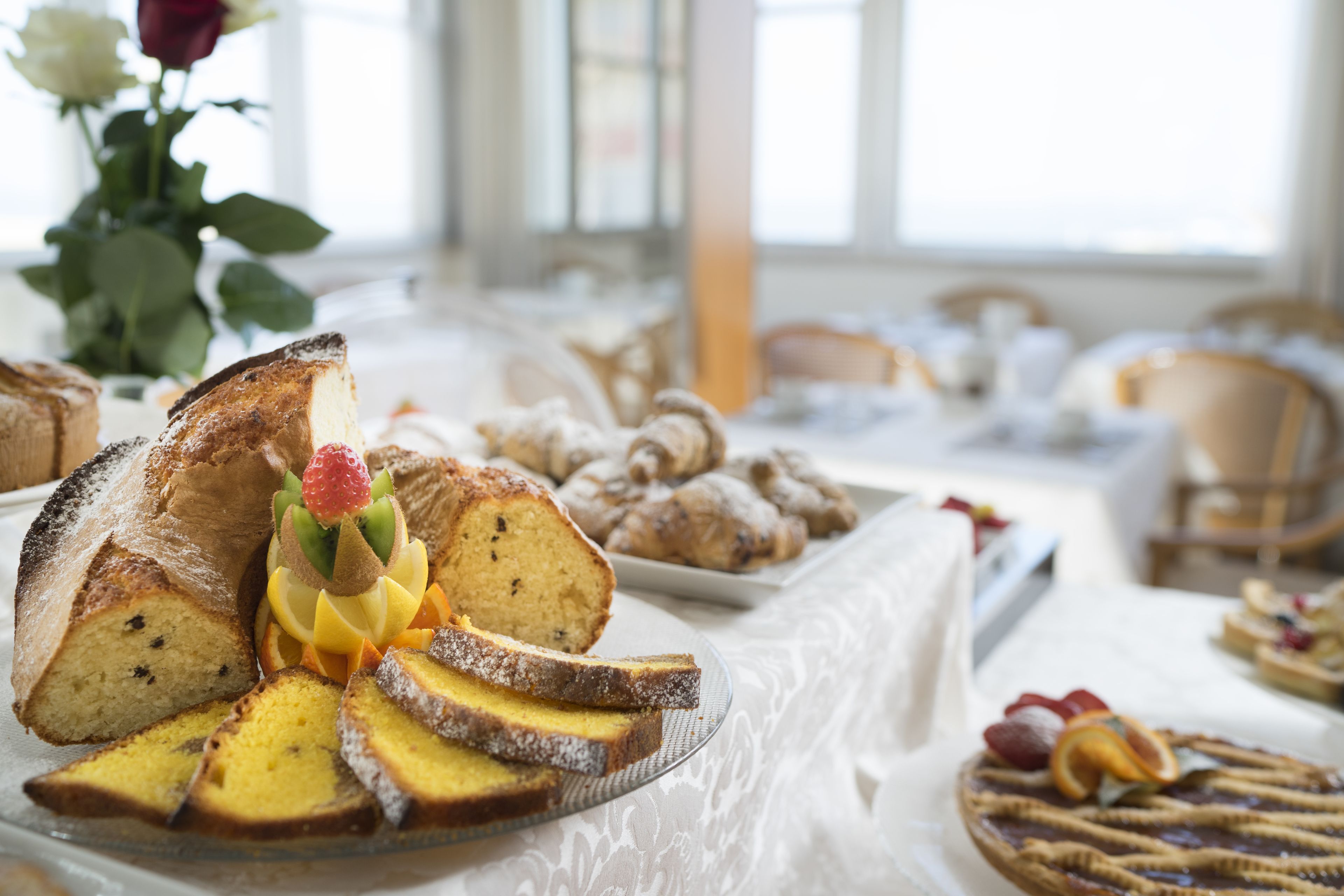 A buffet table with various baked goods and desserts.