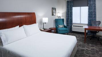 Premium bedding, desk, laptop workspace, blackout drapes