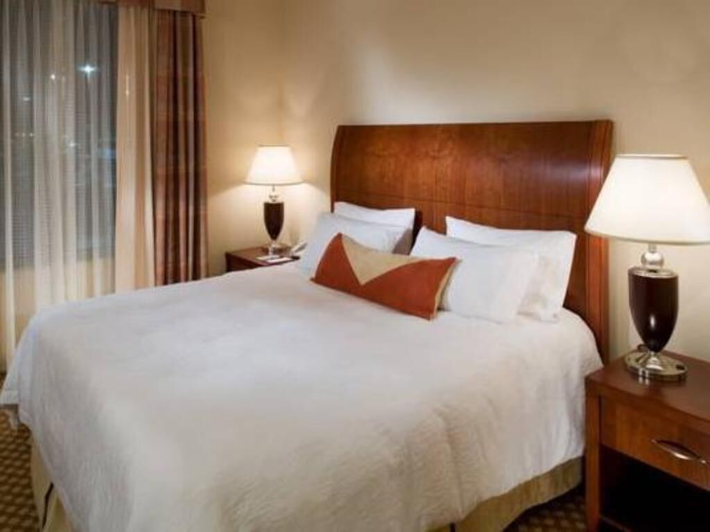 Premium bedding, desk, laptop workspace, blackout curtains