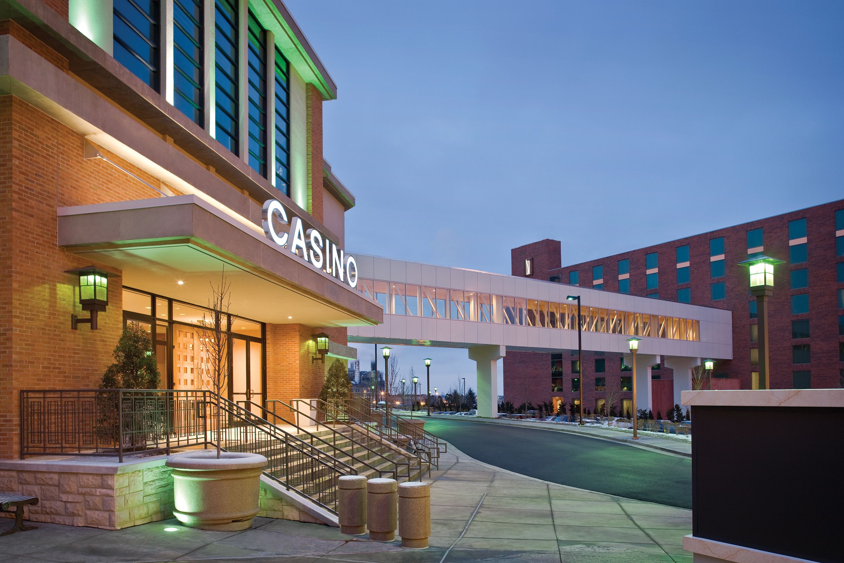 A casino building with a prominent entrance, a covered walkway, and a parking area.