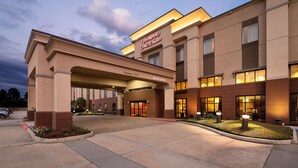 A hotel entrance with a sign reading "Hampton Inn & Suites" and a welcome sign. - Hampton Inn & Suites Baton Rouge - I-10 East (Baton Rouge)