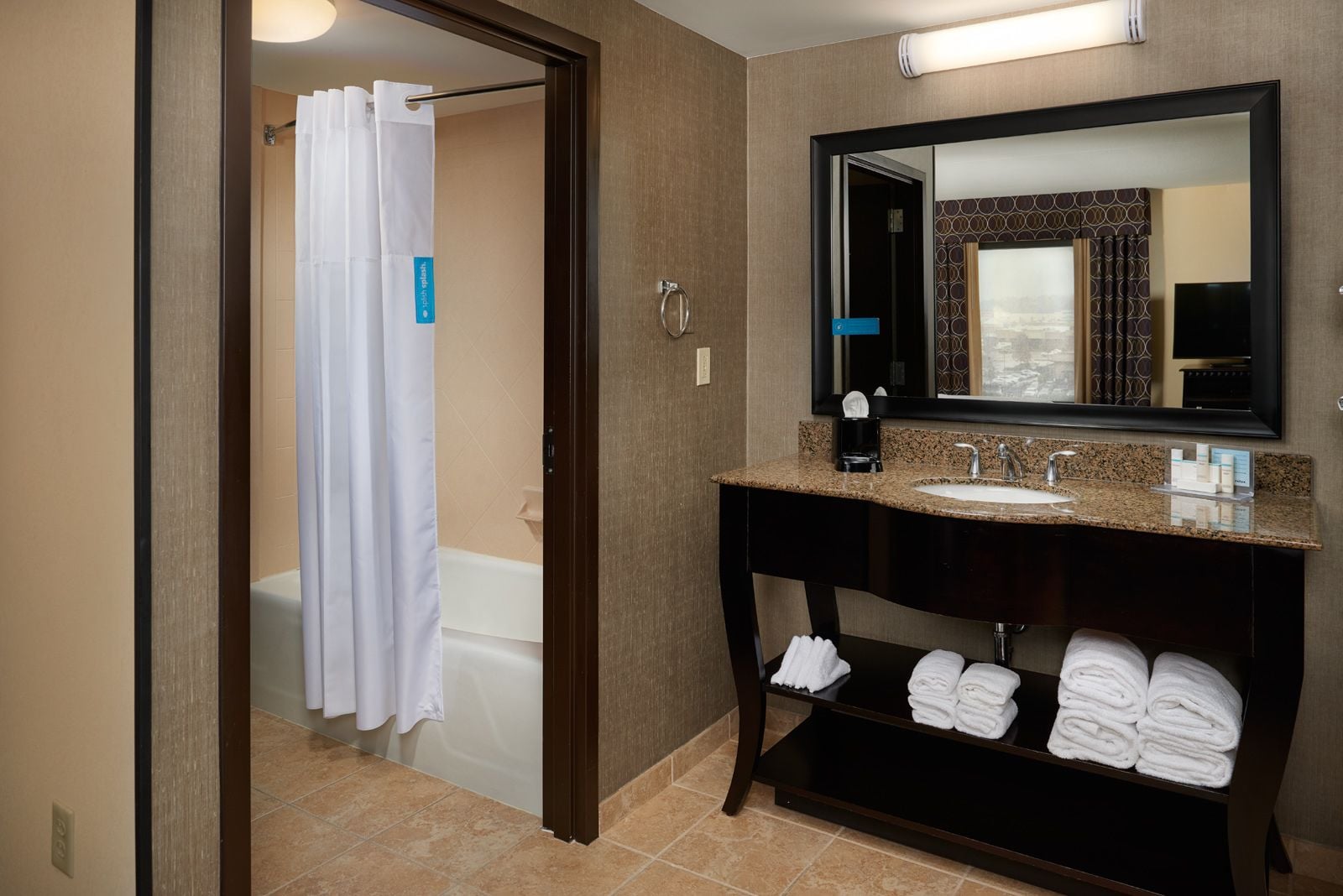 combined shower/bathtub, designer toiletries, hair dryer, towels