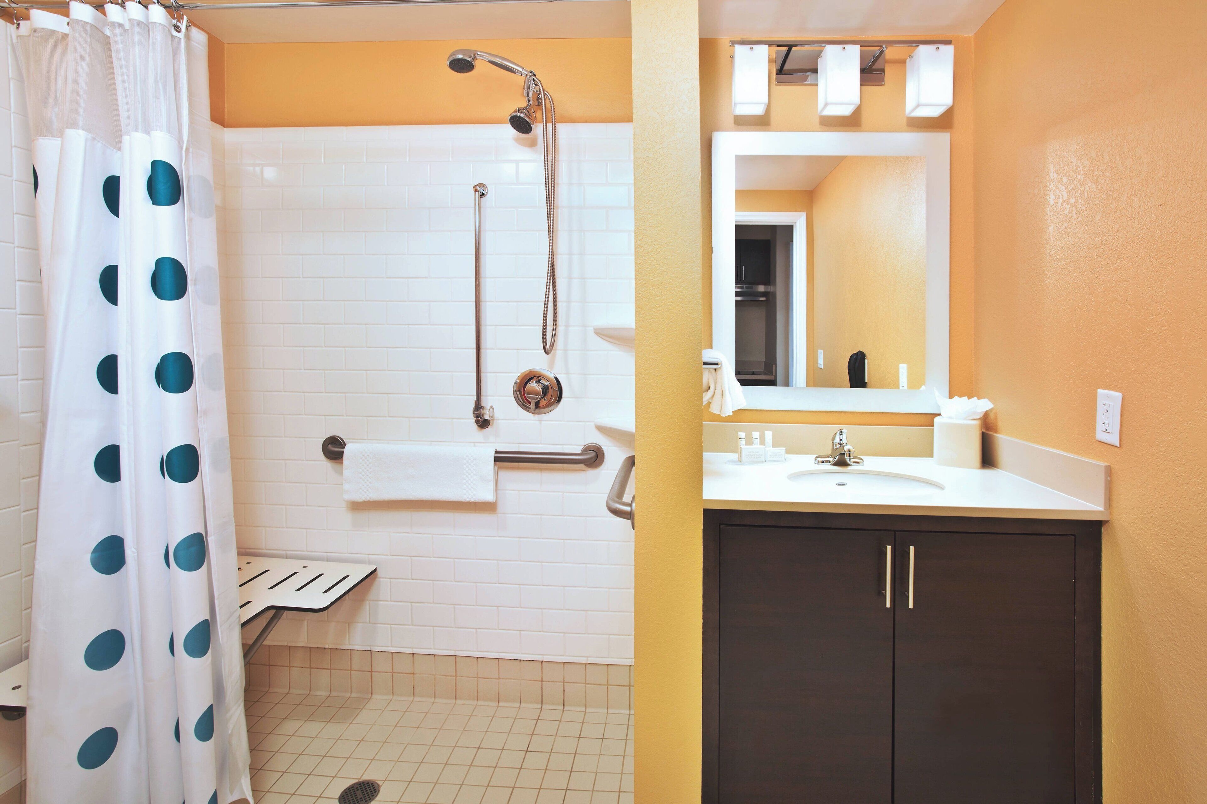 Une salle de bain avec douche, toilettes et lavabo.